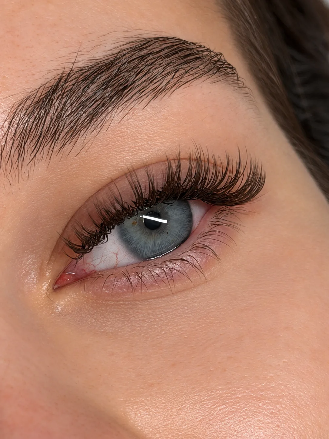 Fluffy volume lash set on a blue eye, close up